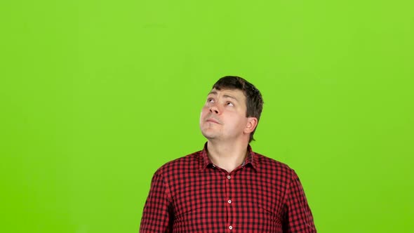 Man Chooses a Product, He Doubts the Choice, but Then He Decides. Green Screen alt