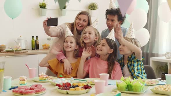 Mother and Kids Taking Birthday Selfie alt