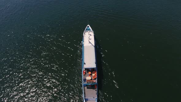 Aerial Shot of a Cargo Barge Moving in the Dnipro on a Sunny Day in Summer  