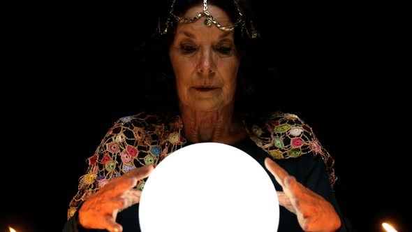 Clairvoyant looking in her crystal ball alt