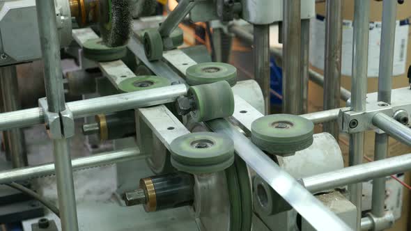 The Mechanism on the Conveyor with Wheels and Round Parts