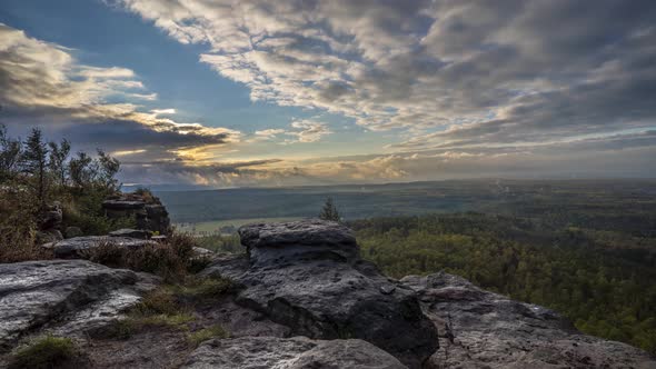 Time lapse of a beautiful place in the mountains region of Bohemian Switzerland at sunset. alt