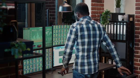 Male Financial Analyst Looking at Real Time Stocks Exchange alt
