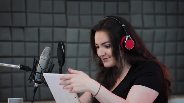 Female voice artist preparing for podcast production process on the sound recording studio alt