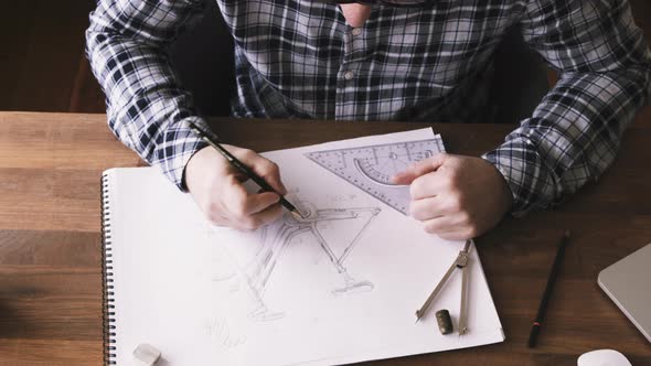 Designer Drawing Plans Of Bicycle At Home Studio alt