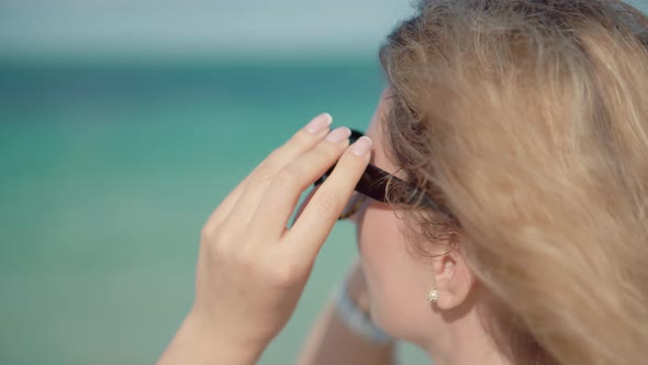 Girl Using Sunglasses On Vacation. Woman Wearing Sunglasses On Ocean Carribean Resort. alt