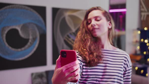 A Young Woman is Making a Selfie alt