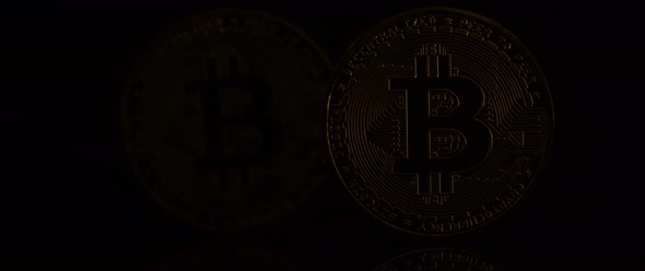 Two Bitcoins on Black Background