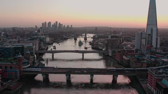 Dolly forward aerial of bridges over Thames river central London early morning sunrise alt