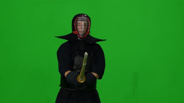 Masculine Kendo Warrior Practicing Martial Art with the Bamboo Bokken on Green Screen. CLose Up alt
