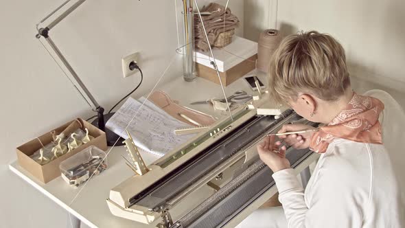 Woman Works behind a Knitting Machine