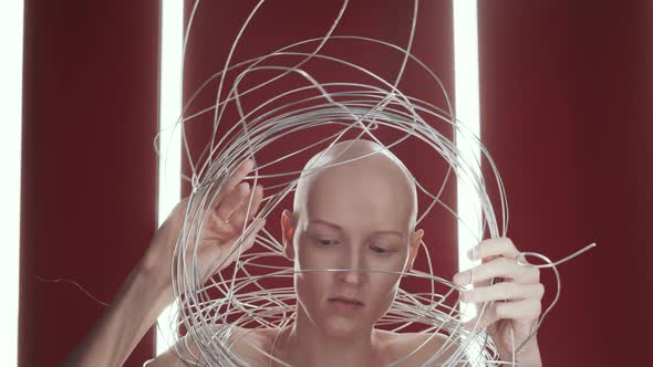 Studio Shot Of Hairless Naked Woman Posing In Tangle Of Wires Stock Footage