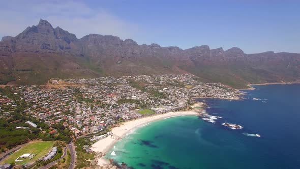 Aerial travel drone view of Camps Bay beach, Cape Town, South Africa. alt