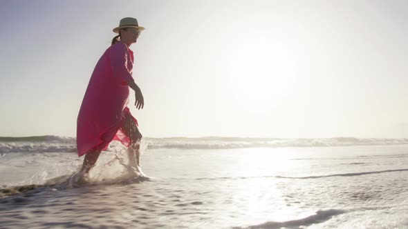 Ocean Waves Crashing at Sandy Beach and Spraying in White Foam and Droplets RED alt
