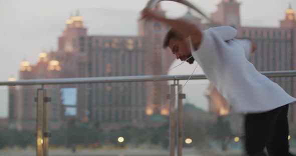 Stunning Atlantis Hotel in the Background of a Man Spinning in a Wheel alt