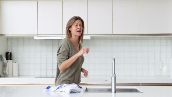 Woman Dancing and Washing Up
