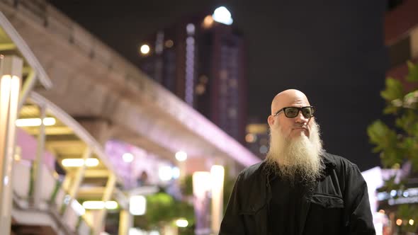 Mature Bearded Tourist Man Against View of the City at Night