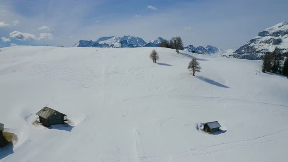 Aerial, Winter Landscape And Huge Mountain Peaks In Dolomites Mountains On A Sunny Day In Italy