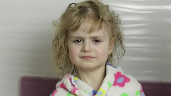 Little Girl with Wet Hair in Bathrobe. Mother Wipes, Dries Her Daughter's Hair alt