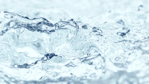 Super Slow Motion Shot of Waving and Splashing Blue Clear Water Surface at 1000Fps alt