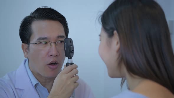 Optical shop concept. The eye doctor is measuring the patient's eyes. 4k Resolution. alt