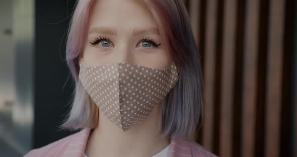 Closeup Slow Motion Portrait of Cute Blonde Wearing Reusable Face Mask Inside alt