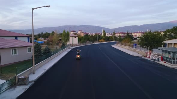 An Asphalt Washing Machine Rides in the Road