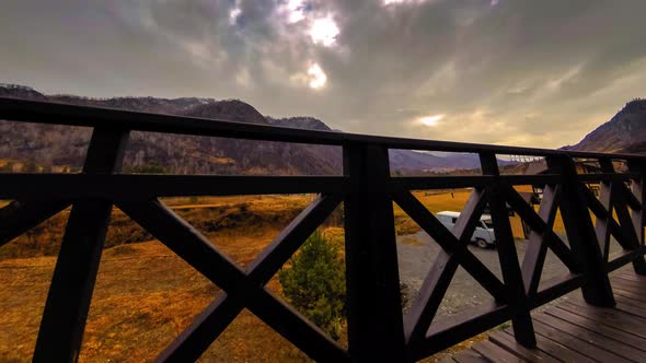 Timelapse of Wooden Fence on High Terrace at Mountain Landscape with Clouds alt