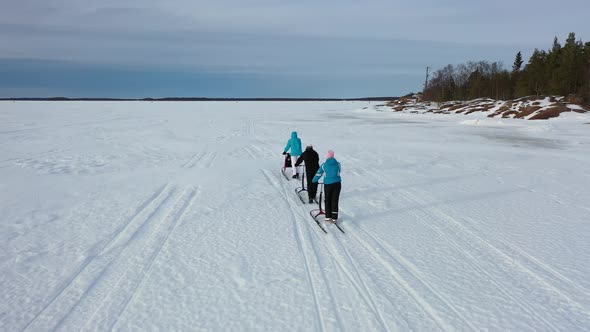 Following Kicksleds On The Ice With A Drone alt