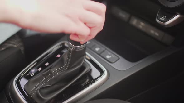 Person Switches Automatic Transmission of Automobile