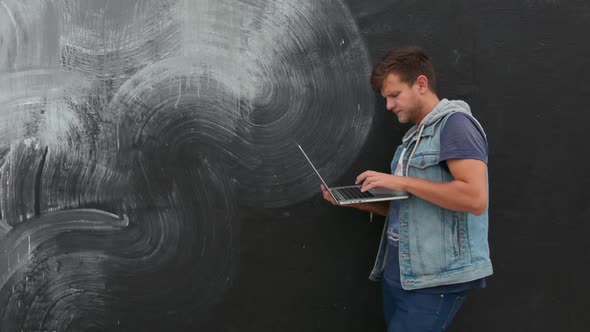 Bearded Man With Laptop On Graffity Wall