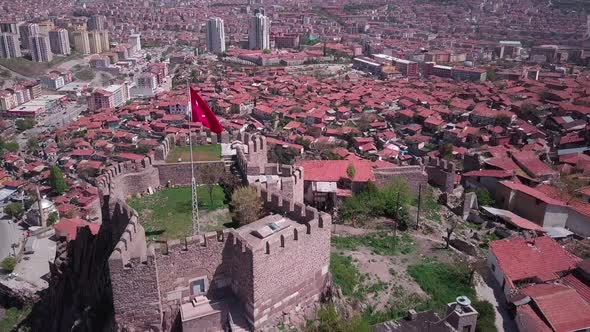 Top of the hill with Ancient Ankara fortress, Turkish flag, main city view. Aerial shot.