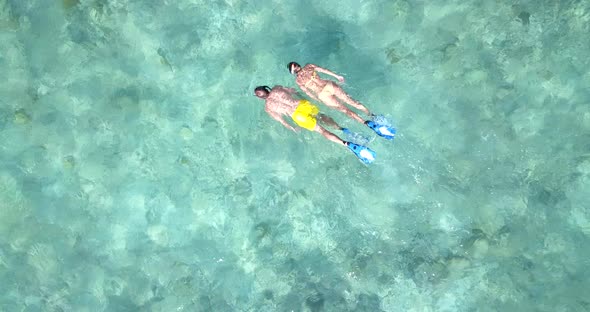 Beautiful lady and man on honeymoon vacation spend quality time on beach on summer white sandy 4K ba alt