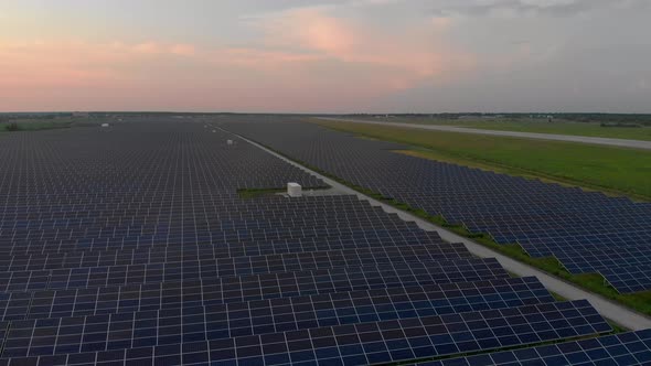 Drone Fly Over Solar Farm. Renewable Green Energy and Electrical Technology. Field of Solar Panels alt
