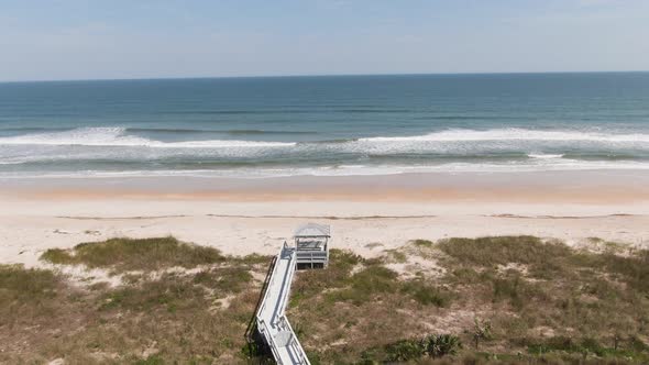 Push in over beach to waves crashing onto the beach from the ocean in Ponte Vedra Florida alt