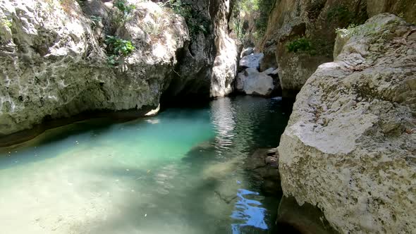 Slow motion: summer adventure in Agios Antonios Gorge, Crete. Holiday concept alt