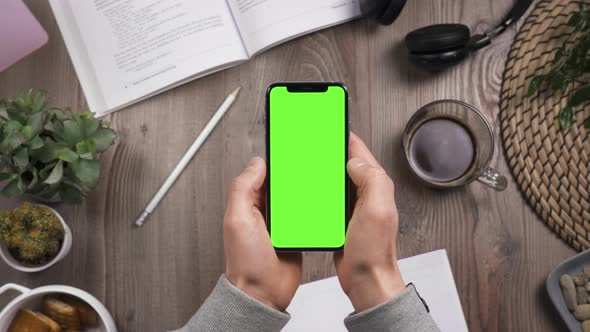Phone with Green Screen Chroma Key in Male Hands. Thumb Finger Swipe Left