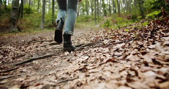 Woman Walking in Boots Lowangle View