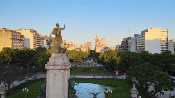 Aerial orbit of bronze monument in Congressional Plaza near Argentine Congress building at sunsetBue alt