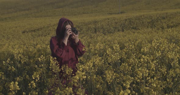 Happy Woman Walking Alone on Morning Flower Field Photographing Nature Sunrise Slow Motion. Young alt