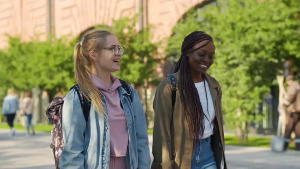Happy University Friends Resting After Classes and Lections Together Outdoors. alt