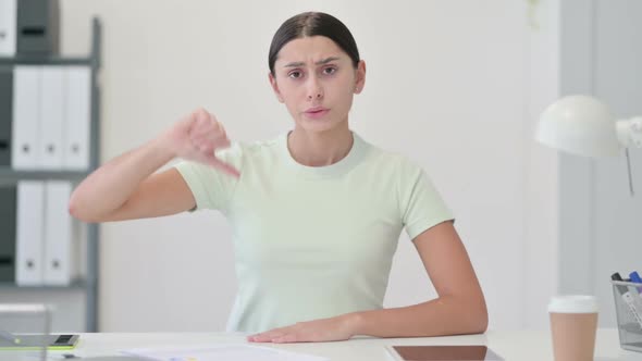 Thumbs Down By Young Latin Woman in Office alt