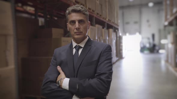 Businessman standing in warehouse
