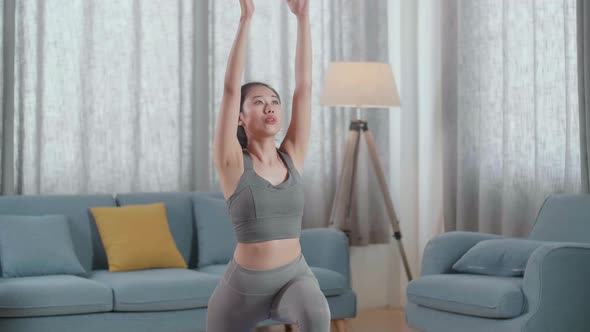 Young Asian Athletic Female In Sports Clothes Practicing Different Asana Poses On The Mat At Home alt