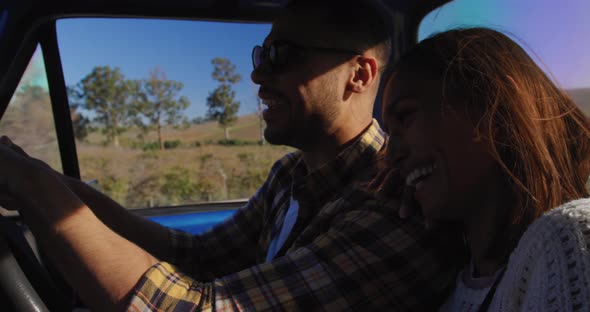 Young couple on a road trip in their pick-up truck alt