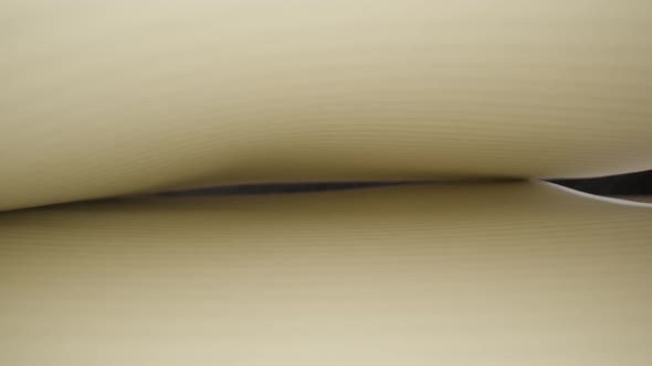 White Lined Pages of Notebook Against Black Wall in Studio