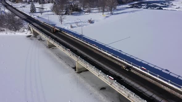 snowmobile is forced to drive on road to cross bridge aerial alt