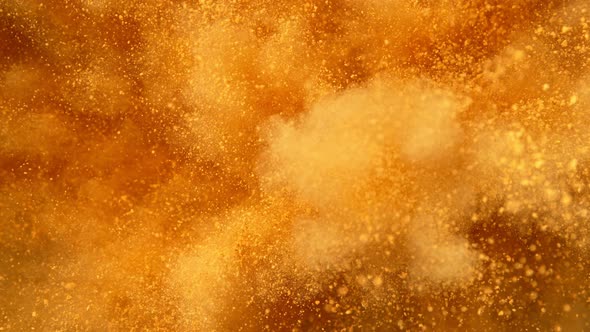 Super Slowmotion Shot of Golden Powder Explosion at 1000Fps alt