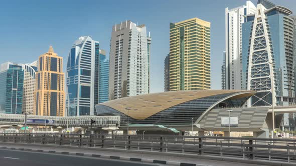 View of Jumeirah Lakes Towers Skyscrapers and Metro Sration Timelapse with Traffic on Sheikh Zayed alt