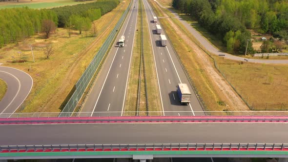 Traffic of cars and trucks on the Freeway in Summer day - top view shot. Top View shot of multi-lane alt